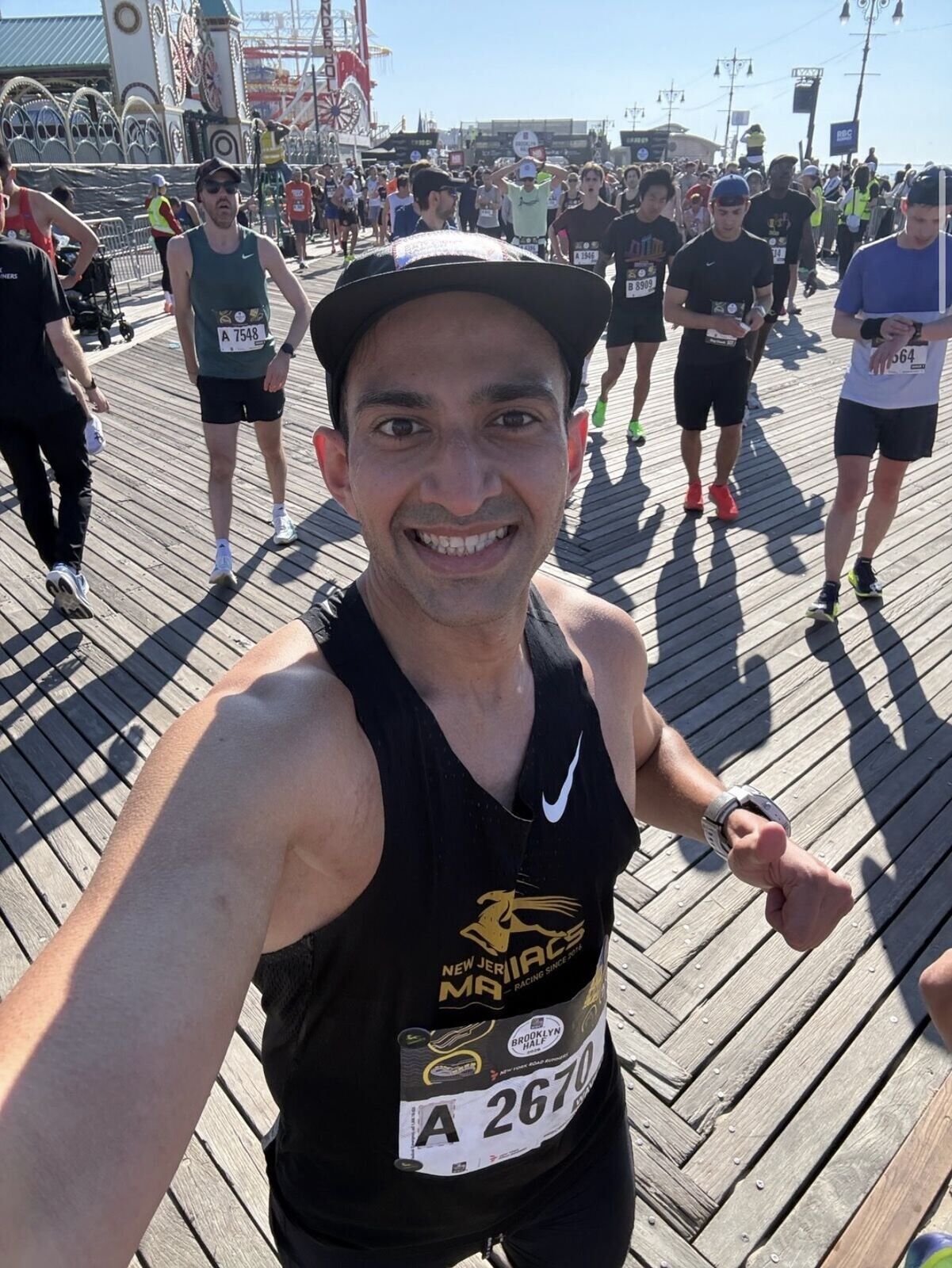 Harsh on the Coney Island boardwalk after the race, wearing bib A2670 and giving a thumbs up